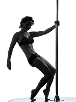 one caucasian woman pole dancer dancing in silhouette studio isolated on white background