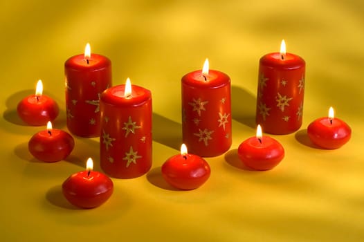 red candles assorted on a yellow background