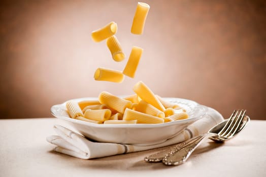Fresh falling macaroni pasta close up shoot
