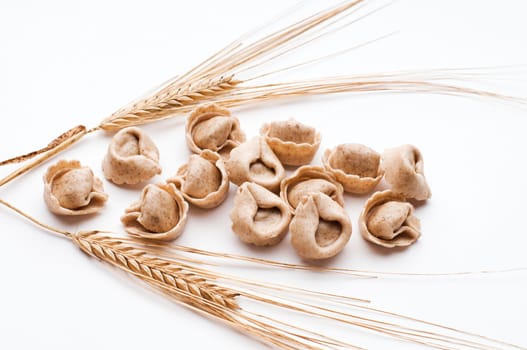 Fresh raw whole grain capeletti isolated on white close up