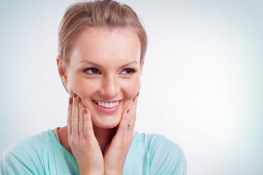 Closeup of happy young woman smiling and side looking