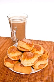 Shortbread cookies with apples and coffee for breakfast standing on a bamboo mat and white background