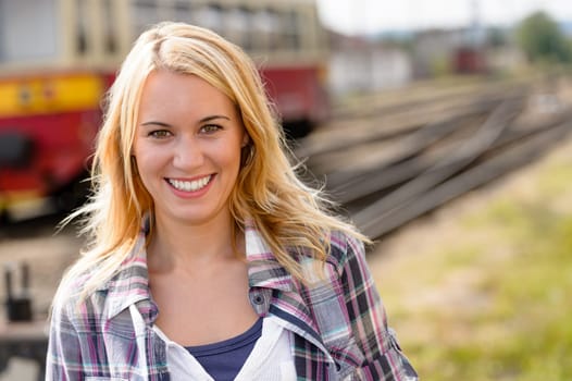 Woman smiling looking at camera vacation railroad tourist trip beautiful
