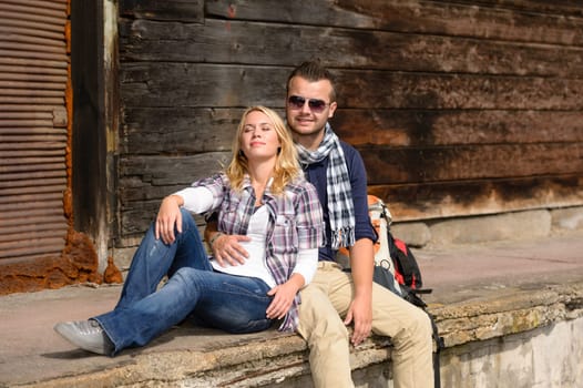Woman resting and leaning on man's shoulder traveling smiling couple