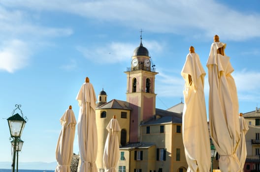 white umbrellas with Camogli Church in the background