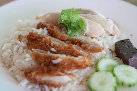 Rice with steamed chicken and fried chicken.