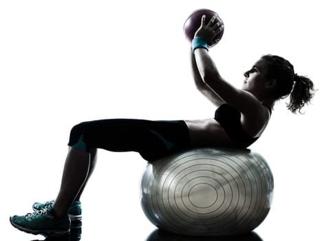 one caucasian woman exercising fitness ball workout posture in silhouette studio isolated on white background