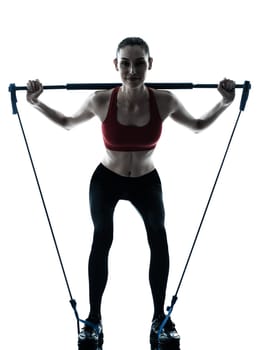 one caucasian woman exercising elastic gymstick in silhouette studio isolated on white background
