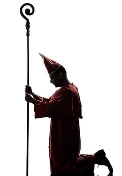 one man cardinal bishop silhouette in studio isolated on white background