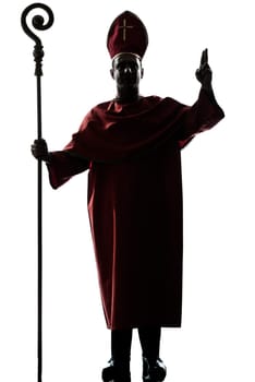 one man cardinal bishop silhouette saluting blessing in studio isolated on white background