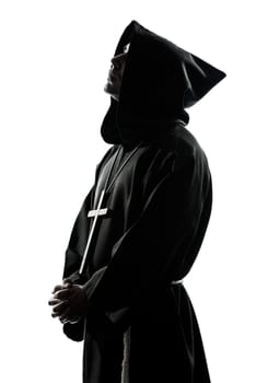 one caucasian man priest praying silhouette in studio isolated on white background
