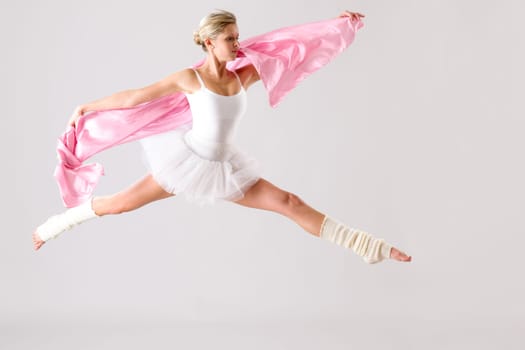 Lovely ballet dancer jumping exercising in studio woman ballerina rehearsal