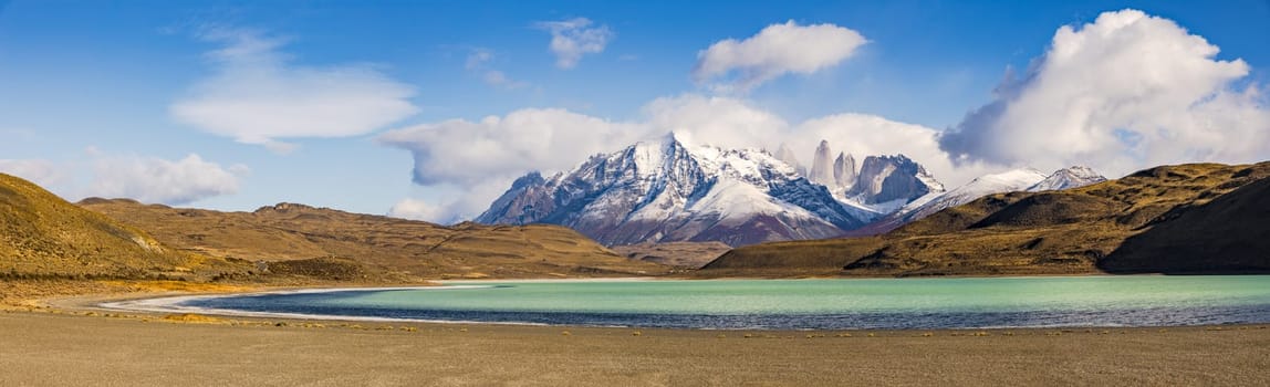 Widescreen panorama with the pointed rock towers in the Torres del Paine mountain massif, the landmark of the national park, Laguna Azul, Chile, Patagonia, South America