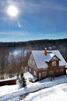 wooden old red cottage in winter with snow in Czech mountains
