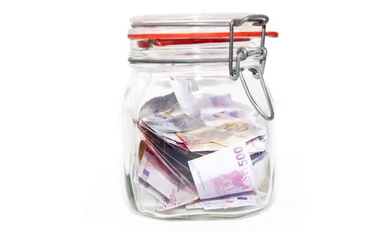 Banknotes in mason jar against white background