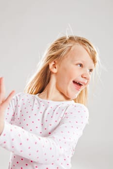 Studio portrait of happy smiling young girl looking to the side