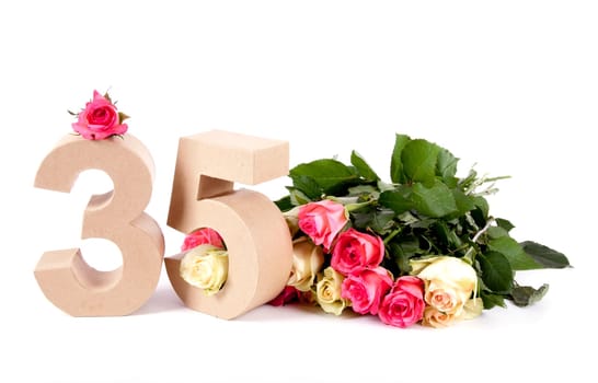 Number of age in a colorful studiosetting,surrounded with roses