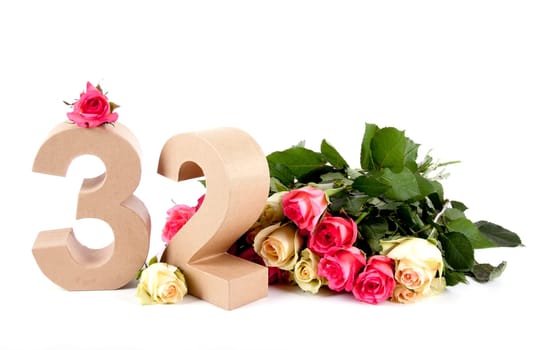 Number of age in a colorful studiosetting,surrounded with roses