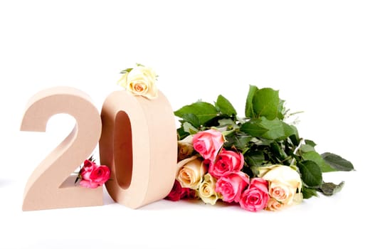 Number of age in a colorful studiosetting,surrounded with roses