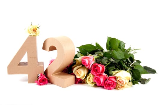 Number of age in a colorful studiosetting,surrounded with roses
