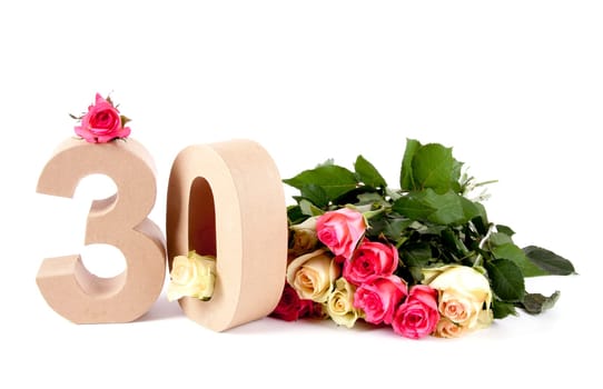 Number of age in a colorful studiosetting,surrounded with roses