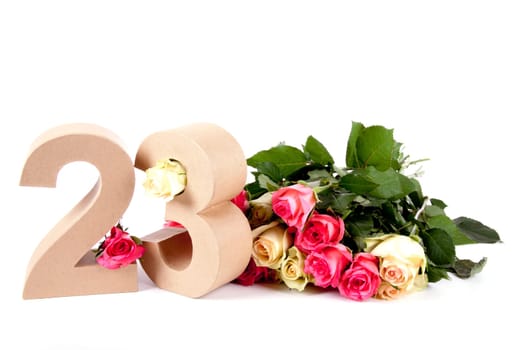Number of age in a colorful studiosetting,surrounded with roses