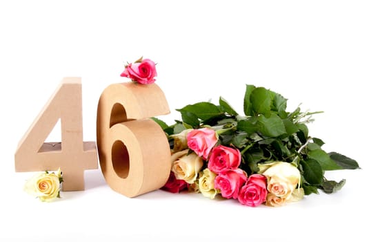 Number of age in a colorful studiosetting,surrounded with roses