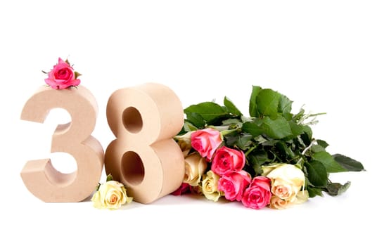 Number of age in a colorful studiosetting,surrounded with roses