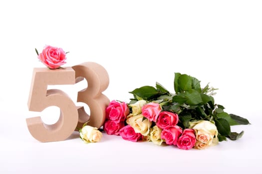 Number of age in a colorful studiosetting,surrounded with roses