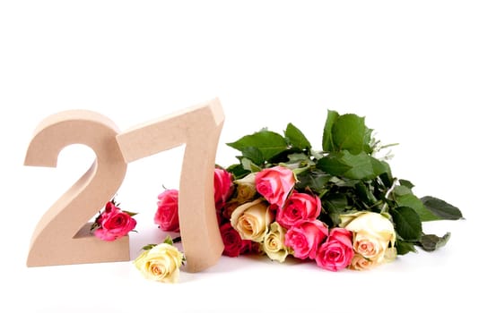 Number of age in a colorful studiosetting,surrounded with roses