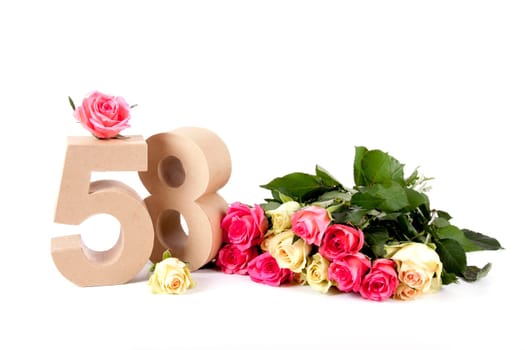 Number of age in a colorful studiosetting,surrounded with roses