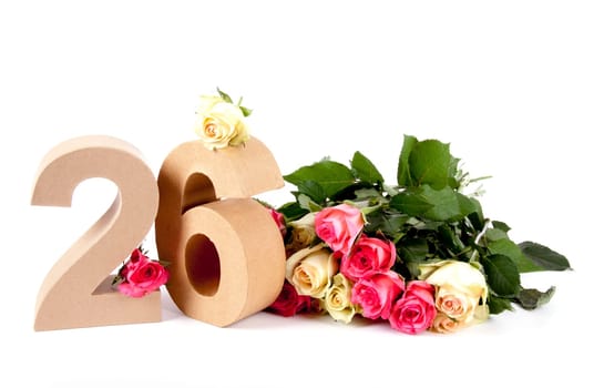 Number of age in a colorful studiosetting,surrounded with roses