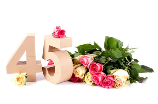 Number of age in a colorful studiosetting,surrounded with roses
