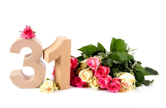 Number of age in a colorful studiosetting,surrounded with roses