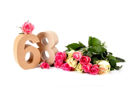 Number of age in a colorful studiosetting,surrounded with roses