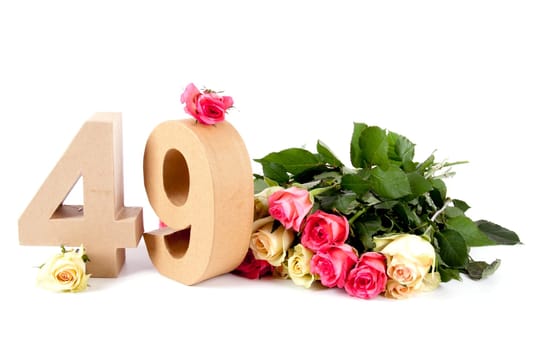 Number of age in a colorful studiosetting,surrounded with roses