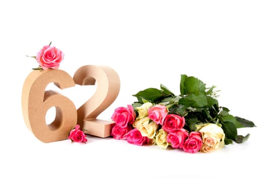Number of age in a colorful studiosetting,surrounded with roses