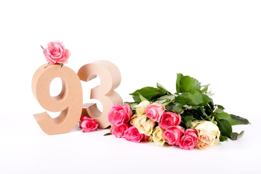 Number of age in a colorful studiosetting,surrounded with roses
