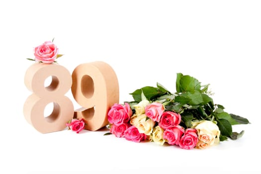 Number of age in a colorful studiosetting,surrounded with roses