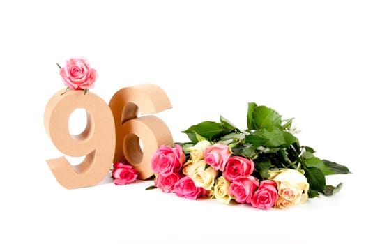 Number of age in a colorful studiosetting,surrounded with roses
