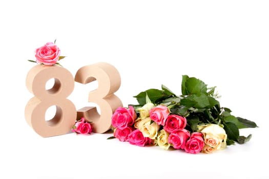 Number of age in a colorful studiosetting,surrounded with roses