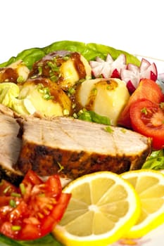Roast pork in tomatoes on the white background