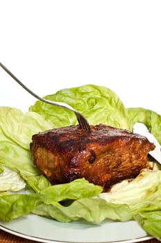 Roast pork in tomatoes on the white background