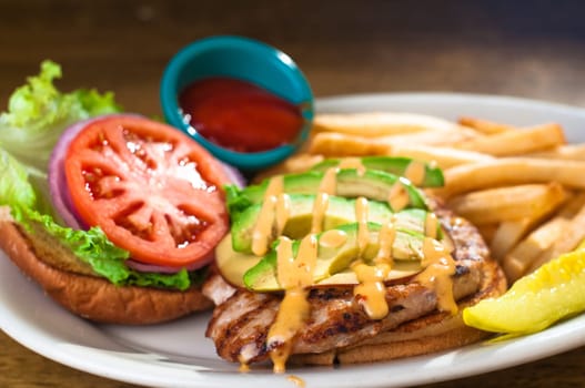 Avocado chicken burger with fries