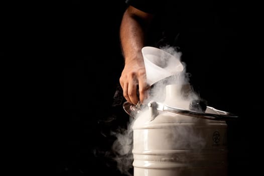 Pouring liquid nitrogen into a dewar on black