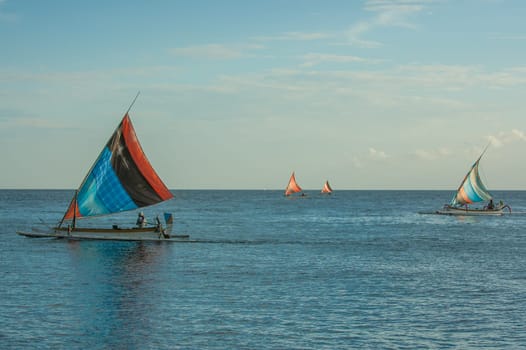 Balinese jukung fishermen coming in with the day's catch