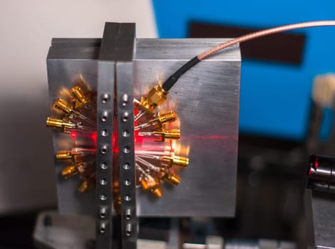 Optical device being hit by a red laser beam