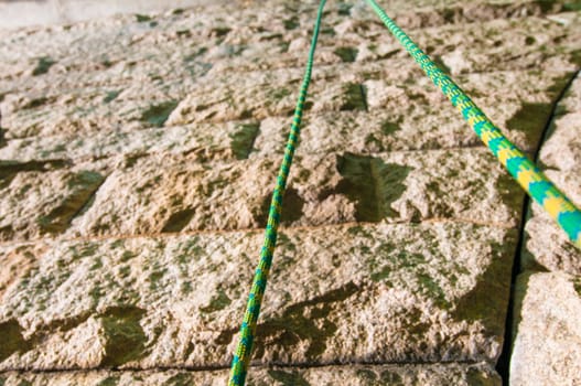 Climbinb rope up close in front of a wall