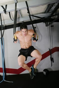 The sportsman the guy, carries out difficult exercise, sports gymnastics.  Ring dip Crossfit exercise.
