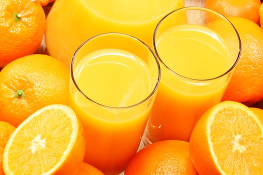 Composition with two glasses of orange juice and fruits